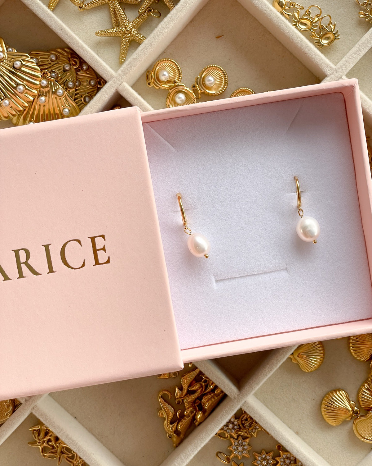 Angel pearl huggie earrings in 18k gold, in a Marice gift box