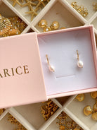 Angel pearl huggie earrings in 18k gold, in a Marice gift box