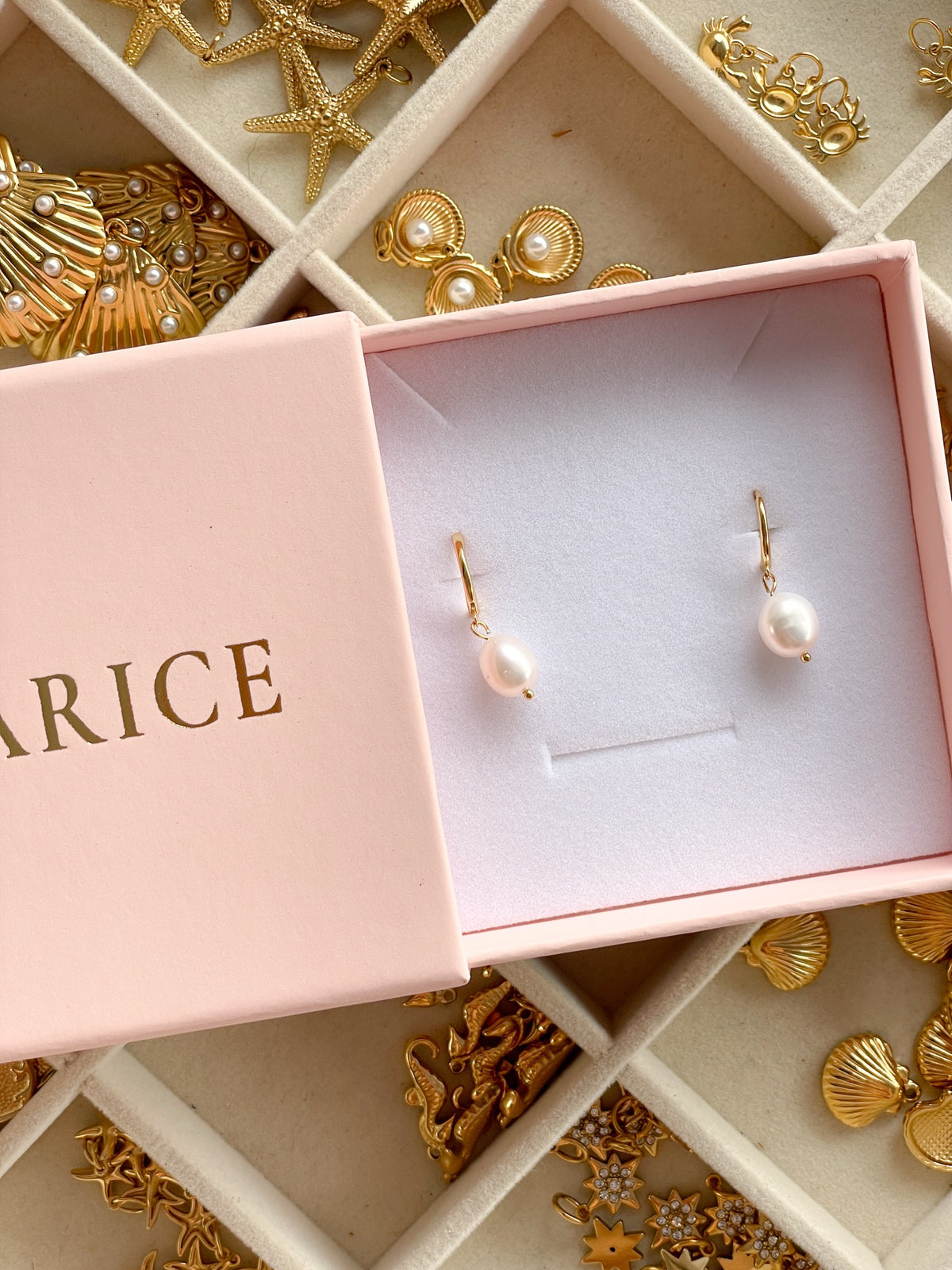 Angel pearl huggie earrings in 18k gold, in a Marice gift box
